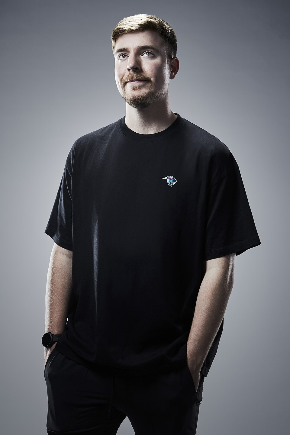 MrBeast wearing a black shirt in a studio portrait