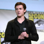 Tom Holland speaking with a microphone at San Diego Comic-Con