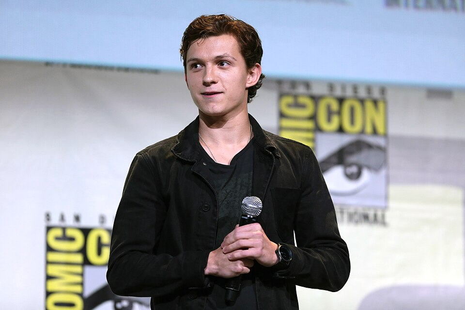 Tom Holland speaking with a microphone at San Diego Comic-Con