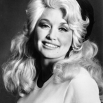 Dolly Parton smiling in a 1970 black-and-white RCA Records portrait