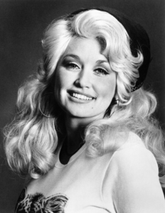 Dolly Parton smiling in a 1970 black-and-white RCA Records portrait