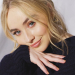 Sabrina Carpenter wearing a black sweater in a 2019 portrait
