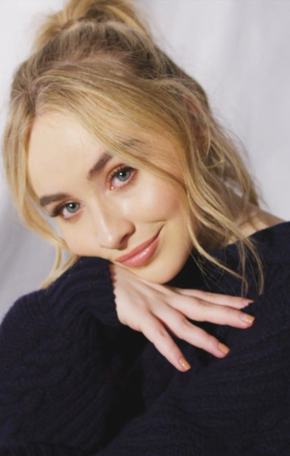 Sabrina Carpenter wearing a black sweater in a 2019 portrait