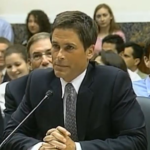 Rob Lowe speaking in 2011, wearing a suit and tie